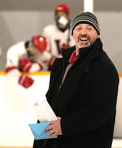 GCB Wildcats head coach Corey Forbes smiles when he gets called back to receive a belated birthday present after a pre-game ceremony marking Forbes’ 800th game behind the bench with the Westman High School Hockey League team on Saturday at Glenboro Arena. (Perry Bergson/The Brandon Sun)