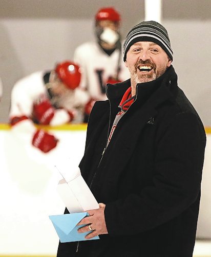 GCB Wildcats head coach Corey Forbes smiles when he gets called back to receive a belated birthday present after a pre-game ceremony marking Forbes&#x2019; 800th game behind the bench with the Westman High School Hockey League team on Saturday at Glenboro Arena. (Perry Bergson/The Brandon Sun)