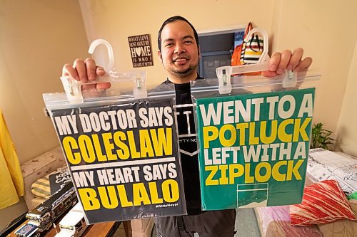 Daniel Crump / Winnipeg Free Press. Adonis Fernandez, 37, shows off some of the filipino themed shirts he designed and sells in his online store. March 2, 2022.