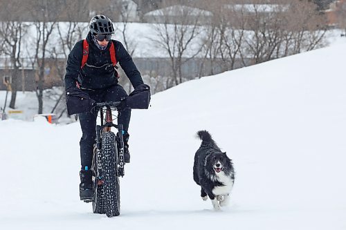 Clayton Heppner and his border collie Chloe cycle and run, respectively, at the Optimist Soccer Park in Brandon on Monday  (Photos by Tim Smith/The Brandon Sun)