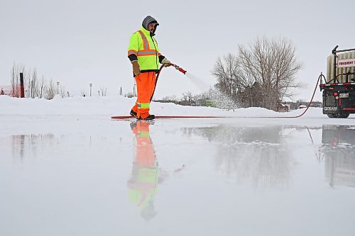 Blaine Moyer, from the City of Brandon parks and recreation department, floods the ice at the skating oval Tuesday morning. (Tim Smith/The Brandon Sun)