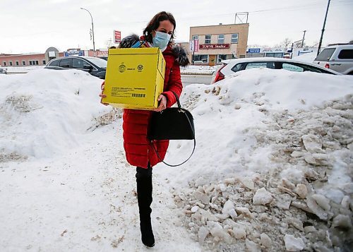 Oksana Derbak delivers a box of requested essentials at the Ukrainian National Federation Tuesday. (John Woods/Winnipeg Free Press)