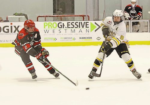 Brandon Wheat Kings forward Nolan Chastko passes the puck as Garrett MacDonald of the Southwest Cougars defends in Manitoba U18 AAA Hockey League action at J&amp;G Homes Arena on Jan. 30, 2022. (Perry Bergson/The Brandon Sun)