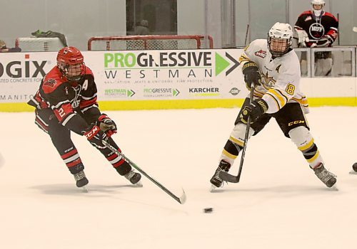 Brandon Wheat Kings forward Nolan Chastko passes the puck as Garrett MacDonald of the Southwest Cougars defends in Manitoba U18 AAA Hockey League action at J&G Homes Arena on Jan. 30. (Perry Bergson/The Brandon Sun)
