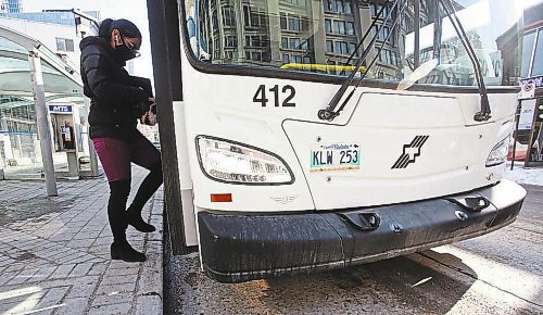 MIKE DEAL / WINNIPEG FREE PRESS

People get on a transit bus at the Graham and Vaughan bus stop in downtown Winnipeg Wednesday morning. 

210303 - Wednesday, March 3, 2021.