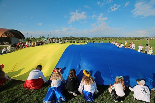 Approximately 100 people were at the Riverbank Discovery Centre to unfurl the largest Ukrainian Flag in Canada in 2021. The flag, which measures 16 by 25 metres, toured the province to mark the 30th anniversary of Ukraine's independence. The event was hosted by the Ukrainian Canadian Congress of Manitoba. (Drew May/The Brandon Sun)
