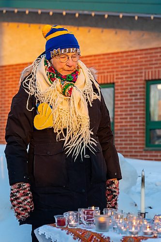 Jann Sirski overlooks candles lit at the Stand with Ukraine rally in front of Dauphin City Hall Wednesday.(Chelsea Kemp/The Brandon Sun)