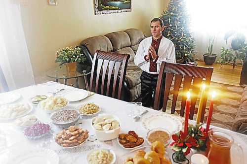 Brandon Sun 06012013 Petro Zaliskyy says a prayer of thanks prior to Ukrainian Christmas Eve dinner at his family's home on Sunday. After dinner the family went caroling at friends and to mass at the Ukrainian Orthodox Church.  (Tim Smith/Brandon Sun)