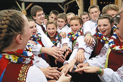 Brandon Sun 31072009 Members of the Selo Ukrainian Dancers from Anola, Man. celebrate after scoring a 99 out of 100 in the amateur talent contest at the 2009 Canada's National Ukrainian Festival just south of Dauphin, Man. on Friday afternoon. The three day festival celebrates everything Ukrainian and is headlined this year by Ukrainian vocalist Ruslana.  (Tim Smith/Brandon Sun)