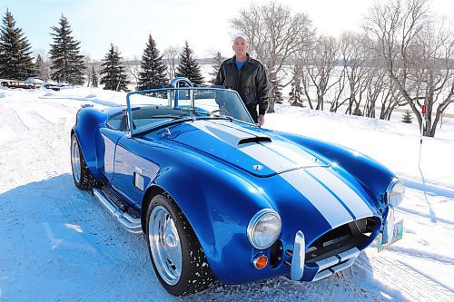 Gord Chester poses for a photo with his replica Shelby Cobra outside his home on Thursday morning. Chester told the Sun that he had ambitions of owning a Cobra since his youth and opted to build his own with a roadster kit due to the rarity of this famous British sports car. (Photos by Kyle Darbyson/The Brandon Sun)