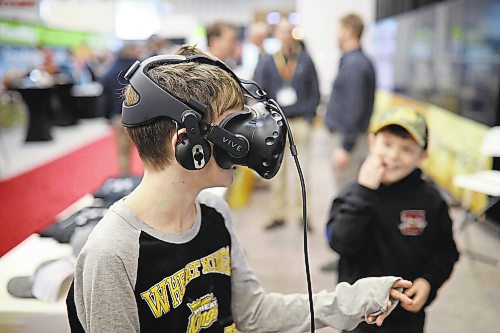 Brandon Sun 24012019

Ten-year-old Matthias Chevalier tries out a virtual reality simulation at the Farmers Edge booth as his younger brother Lucas looks on during the final day of Manitoba Ag Days 2019 at the Keystone Centre.   (Tim Smith/The Brandon Sun)