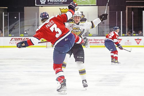 04032022
Jesiah Bennett #23 of the Brandon Wheat Kings knocks Chase Pauls #3 of the Lethbridge Hurricanes off his feet during WHL action at Westoba Place on Friday evening. 
(Tim Smith/The Brandon Sun)