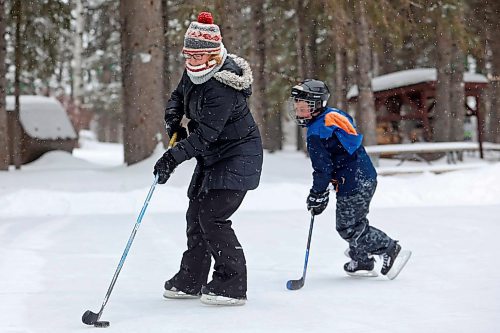Erin Majcher of Winnipeg plays shinny with her son Marcus as well as her husband Miles and daughter Rhea on the rink in Wasagaming on a snowy Friday afternoon. (Tim Smith/The Brandon Sun)