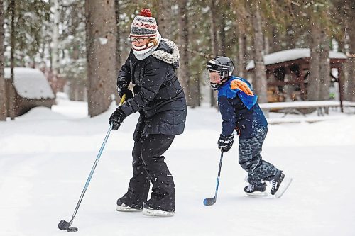 Brandon Sun 04032022

Erin Majcher of Winnipeg plays shinny with her son Marcus as well as her husband Marcus and daughter Rhea on the rink in Wasagaming on a snowy Friday afternoon.   (Tim Smith/The Brandon Sun)