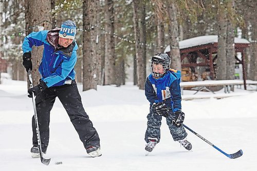 Brandon Sun 04032022

Miles Majcher of Winnipeg plays shinny with his son Marcus as well as his wife Erin and daughter Rhea on the rink in Wasagaming on a snowy Friday afternoon.   (Tim Smith/The Brandon Sun)