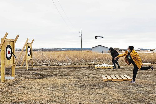 Adele Sinclair throws her axe during the women&#x573;&#x560;hatchet contest at the Wipazoka Wakpa Winter Culture Camp Saturday in Sioux Valley Dakota Nation. (Chelsea Kemp/The Brandon Sun)