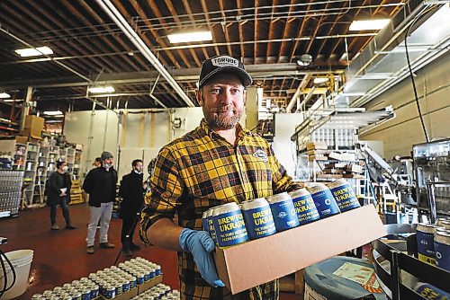 RUTH BONNEVILLE / WINNIPEG FREE PRESS



ENT - beer for Ukraine



Matthew Wolff (cap), Operations Manager at Torque Brewing, along with Kyle Maskiiw canning operator, are thrilled to start production of Ukraine Brew Friday.. Three thousand cans of the unique recipe will be produced with proceeds going to the Ukraine Crisis.  



Subject: Eight local craft breweries in Winnipeg are collaborating on a beer, with all proceeds going to a humanitarian relief fund in Ukraine. The beer recipe is from Pravda Brewing, a Ukrainian brewery based in Lviv.



The breweries collaborating are: Torque Brewing, Trans Canada Brewing, Nonsuch Brewing, Barn Hammer Brewing, One Great City Brewing, Devil May Care Brewing, Lake of the Woods Brewing, and Stone Angel Brewing.



Eva Wasney







April 8th,  2022