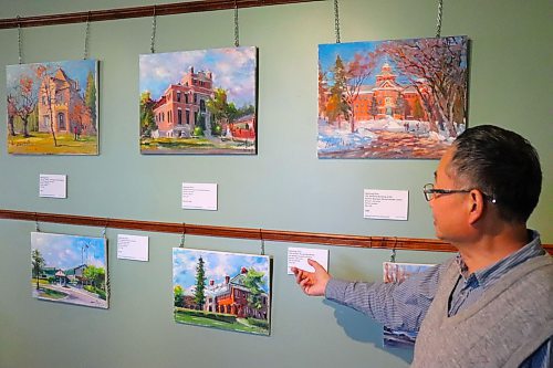 Weiming Zhao showcases some of the oil paintings that are currently on display at the Daly House Museum as a part of his new &quot;Brandon Heritage en Plein Air&quot; exhibition. This solo show is scheduled to run until Sept. 30, with Zhao also planning to take part in an open house on April 23. (Kyle Darbyson/The Brandon Sun) 