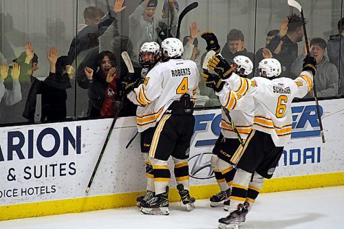 Overtime hero Clarke Caswell is embraced by Brandon Wheat Kings teammate Nolan Roberts as Braden Keeble and Dylan Schrader join in the celebration after their 6-5 win over the Winnipeg Wild in Game 1 of the Manitoba U18 AAA Hockey League final at the J&amp;G Homes Arena Friday. (Lucas Punkari/The Brandon Sun)