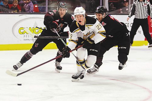 Brandon Wheat King Nate Danielson rushes the net trailed by Moose Jaw Warriors Cole Jordan, left, and Eric Alarie in a Western Hockey League game Saturday at Westoba Place. (Chelsea Kemp/The Brandon Sun)