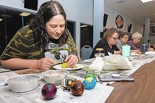 Adri Lee adds a second layer of bee&#x573; wax to decorate her egg during a pysanky workshop Saturday at the Souris-Glenwood Memorial Complex. (Chelsea Kemp/The Brandon Sun)