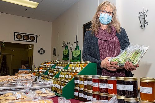 President and co-ordinator of the Brandon Farmers’ Market Jeannette Ens holds asparagus at her booth Cranbrook Gardens in the Town Centre Friday. (Chelsea Kemp/The Brandon Sun)