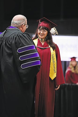 Brandon Sun 03062022

Valedictorian and Social Service Worker Diploma graduate Alexis Cinq-Mars receives her diploma from ACC President Mark Frison during Assiniboine Community College&#x2019;s 2022 graduation ceremony at Westoba Place on Friday. 

(Tim Smith/The Brandon Sun)