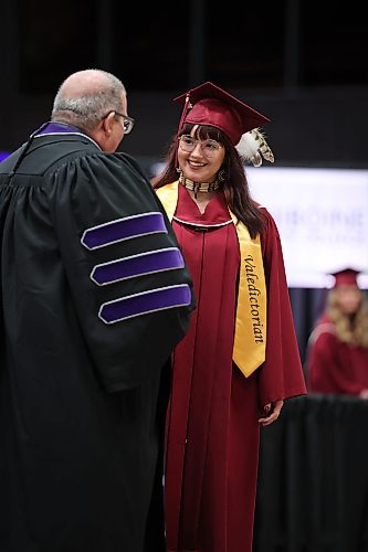 Valedictorian Alexis Cinq-Mars receives her diploma from ACC president Mark Frison during Assiniboine Community College’s 2022 graduation ceremony at Westoba Place Friday. (Tim Smith/The Brandon Sun)