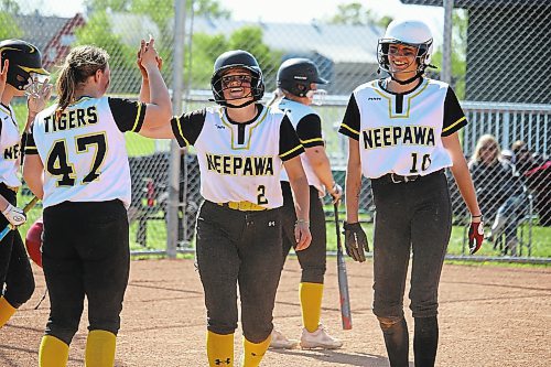 Peyton McLaughlin (2) of the Neepawa Tigers gets a high-five from teammate Madisyn Robertson (47) after hitting a three-run inside-the-park home run against the Nellie McClung Stingers on Friday afternoon at the Ashley Neufeld Softball Complex. (Lucas Punkari/The Brandon Sun)
