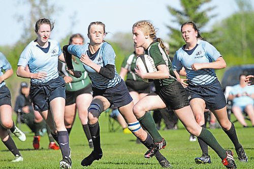 Rivers Rams Payton McNish, second from left, chases down Dauphin Clippers Rhoda Evans during the Westman High School Rugby girls final in Rivers on Friday. (Thomas Friesen/The Brandon Sun)