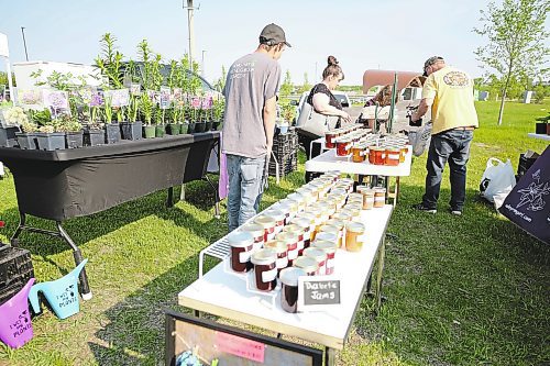 Shoppers got an early start at the first Market at the Riverbank for the summer on Saturday, with Valleyrim doing brisk business selling jams and jellies made with fruit and flowers grown at the farm, as well as perennials and garden plants. (Karen McKinley/The Brandon Sun) 