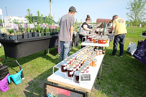 Shoppers got an early start at the first Market at the Riverbank for the summer on Saturday, with Valleyrim doing brisk business selling jams and jellies made with fruit and flowers grown at the farm, as well as perennials and garden plants. (Karen McKinley/The Brandon Sun) 
