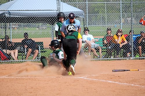 Kassidy Loewen of the Neelin Spartans slides into home plate to score a run during the seventh inning of the provincial final against the Boissevain Broncos. (Lucas Punkari/The Brandon Sun)