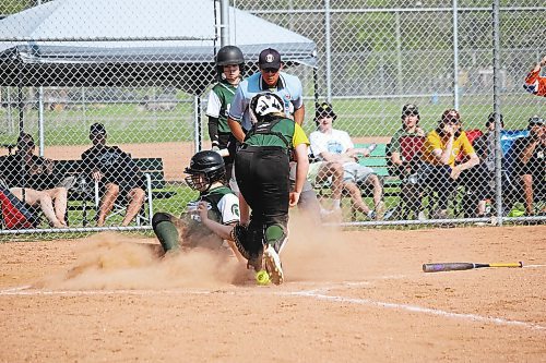 Kassidy Loewen of the Neelin Spartans slides into home plate to score a run during the seventh inning of the provincial final against the Boissevain Broncos. (Lucas Punkari/The Brandon Sun)