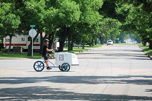 James McDermid rides his ice cream tricycle south on 26th Street selling frozen treats on a warm summer afternoon. He said he rides around to community events all around the city. (Drew May/The Brandon Sun)
