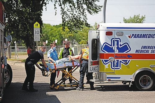 Brandon Sun Emergency crews at the scene of a collision between a pedestrian and a pickup truck load an injured man into the back of an ambulance on Tuesday afternoon, at the corner of 18th Street and McTavish Avenue. (Matt Goerzen/The Brandon Sun)
