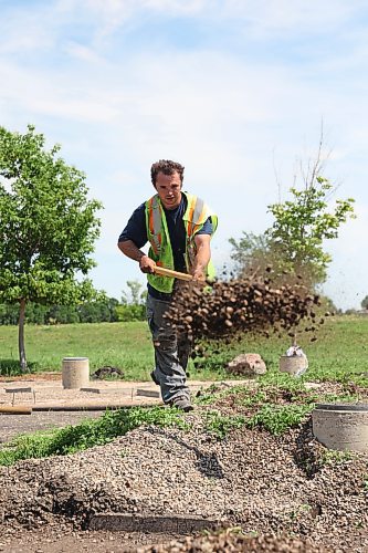 John Duval, groundskeeper with the Riverbank Discovery Centre, digs at the site of the Labyrinth of Peace, which was installed in 2002 by Brandon University. The labyrinth was designed to note the many religions, cultures, and communities that coexist within Brandon and the surrounding area, and the symbols each religion or culture uses to represent itself. The site is in need of renovation, and Duval says he and his partner on the project, Lucas Vasconcelos, hope to complete the work by mid-August. (Matt Goerzen/The Brandon Sun)
