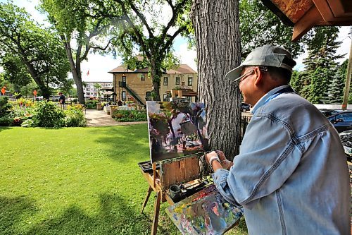 Brandon artist Weiming Zhao paints a scene at the Daly House Wednesday morning during Brandon Downtown Ambassadors' Tea at the Daly House event. (Drew May/The Brandon Sun)