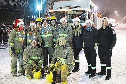 Members of Brandon Fire and Emergency Services pose for a group photo Saturday evening, minutes before the 2022 Brandon Santa Parade was scheduled to begin. (Kyle Darbyson/The Brandon Sun)