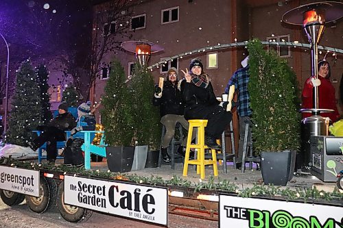 Members of The Greenspot, The Secret Garden Café and The BloomBox wish local families 'Happy Holidays' during Saturday's Brandon Santa Parade. (Kyle Darbyson/The Brandon Sun) 