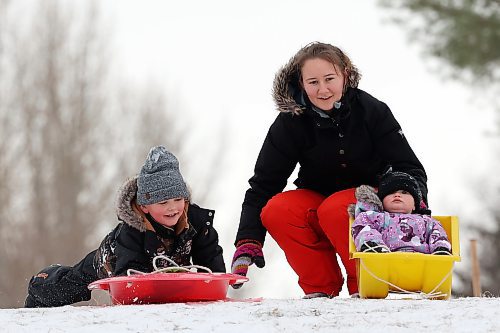 Siblings Liam and Reagen Waldner toboggan with their mom Joyce at the sugar bowl on 34th Street on a mild Monday. (Tim Smith/The Brandon Sun)
