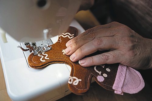 Daniel Crump / Winnipeg Free Press. Tammy Mayberry, co-owner of Emerson&#x573; Playroom, works on a Christmas themed gingerbread man toy in her home workshop. November 26, 2022.