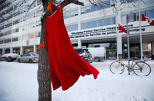 JOHN WOODS / WINNIPEG FREE PRESS
A red dress hangs sways in the wind outside the Winnipeg Police headquarters Tuesday, December 6, 2022. Chief Danny Smyth and Inspector Cam MacKid spoke about the landfill searches in a serial killer case during a press conference at the headquarters.