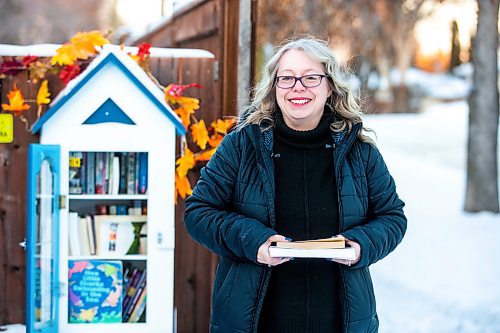 MIKAELA MACKENZIE / WINNIPEG FREE PRESS

Lisa Feyereisen poses for a photo with her little free library on Rossmere Crescent  in Winnipeg on Wednesday, Dec. 7, 2022. For Rachel story.
Winnipeg Free Press 2022.