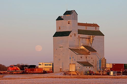07122022
December's full moon, known as the cold moon, long night moon, or moon before Yule, rises to the northeast behind the Harte elevator in western Manitoba as a CN train passes by on a crisp and clear late Wednesday afternoon.  (Tim Smith/The Brandon Sun)