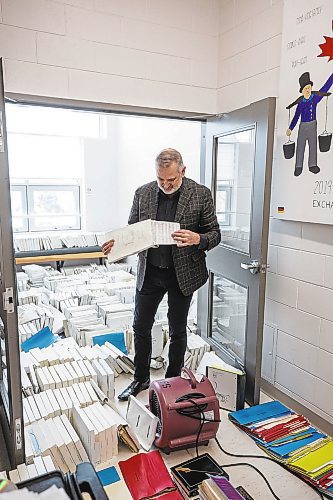 MIKE DEAL / WINNIPEG FREE PRESS
Vic Pankratz choral director sorts through damaged choral papers drying in a room at the school.
A sprinkler in Westgate Mennonite Collegiate went off mistakenly last night and flooded several rooms, including the Music Room, Library and the atrium. Historic choral papers, from the very beginning of the school's history in 1958, have been destroyed. The music teachers are devastated - as are the administrators and families. The school prides itself on being a music powerhouse, with choir mandatory for all G6-9 students, and optional - although many students take it - in 10-12. 
See Maggie Macintosh story 
221208 - Thursday, December 08, 2022.