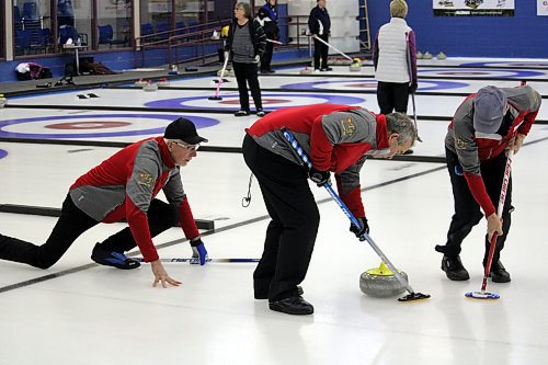 Skip Dale Brooks watches on as lead Don Williams and second Tim Weber sweep a rock during Thursday's Westoba Credit Union Masters Super League at the Brandon Curling Club. (Lucas Punkari/The Brandon Sun)