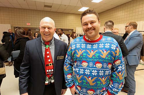 Brandon Chamber of Commerce past president Barry Cooper (left) and LINKS Institute CEO John Jackson (right) showed off their holiday spirit at the chamber's Thursday luncheon with a jolly tie and light-up sloth sweater respectively. (Colin Slark/The Brandon Sun)