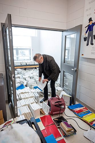 MIKE DEAL / WINNIPEG FREE PRESS
Vic Pankratz choral director sorts through damaged choral papers drying in a room at the school.
A sprinkler in Westgate Mennonite Collegiate went off mistakenly last night and flooded several rooms, including the Music Room, Library and the atrium. Historic choral papers, from the very beginning of the school's history in 1958, have been destroyed. The music teachers are devastated - as are the administrators and families. The school prides itself on being a music powerhouse, with choir mandatory for all G6-9 students, and optional - although many students take it - in 10-12. 
See Maggie Macintosh story 
221208 - Thursday, December 08, 2022.