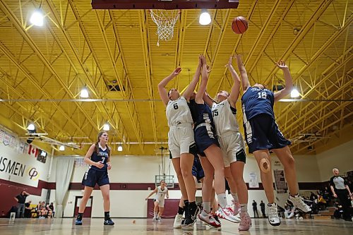 Neelin Spartans and Swan River Tigers players jostle for a rebound during their Crocus Plains Early Bird varsity girls basketball tournament game on Friday. (Tim Smith/The Brandon Sun)